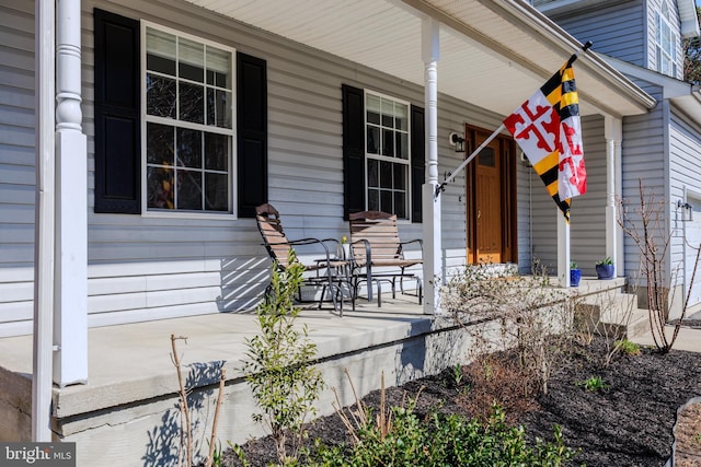 view of exterior entry featuring a porch