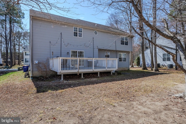 back of house with a deck