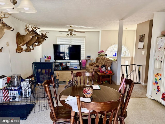 dining room featuring tile patterned floors, baseboards, and ceiling fan