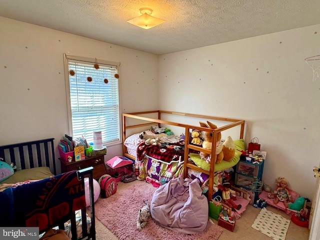 bedroom with a textured ceiling and carpet