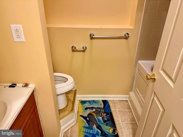 bathroom featuring tile patterned flooring, toilet, vanity, and baseboards