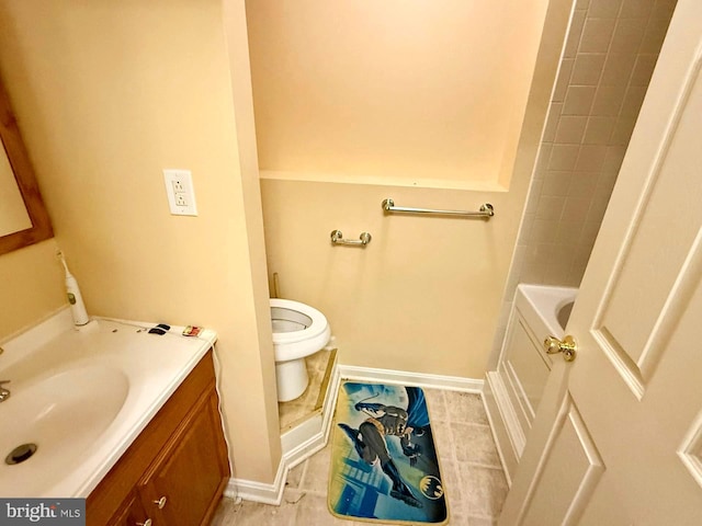 bathroom with baseboards, toilet, a bathtub, vanity, and a shower