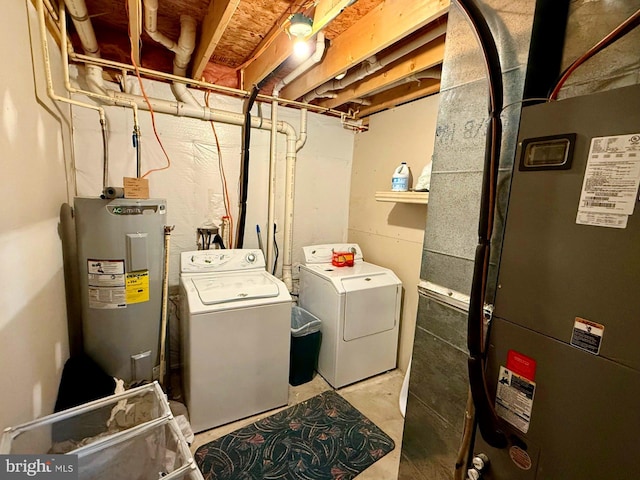 laundry room with laundry area, heating unit, separate washer and dryer, and water heater