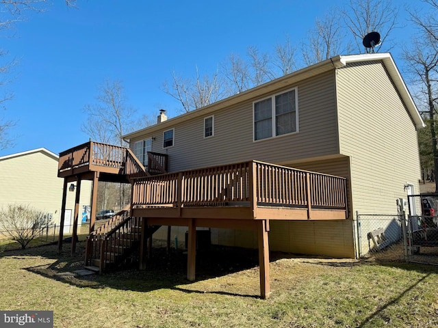 back of house with stairs, fence, a lawn, and a wooden deck