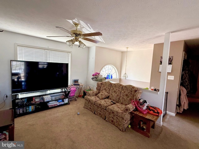 carpeted living room with a textured ceiling and ceiling fan