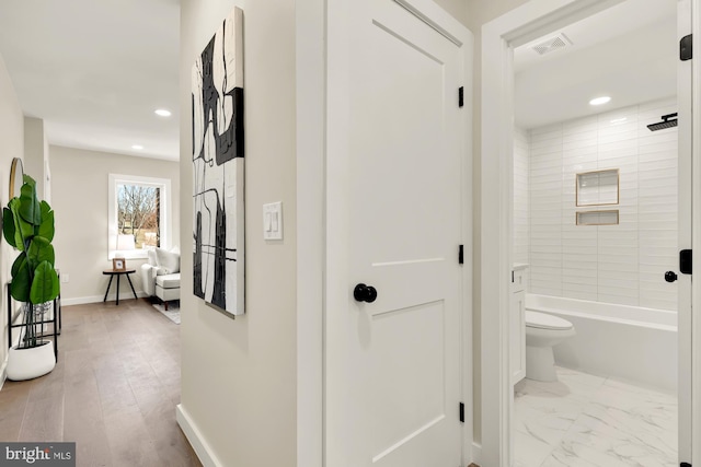 hallway featuring recessed lighting, baseboards, visible vents, and marble finish floor