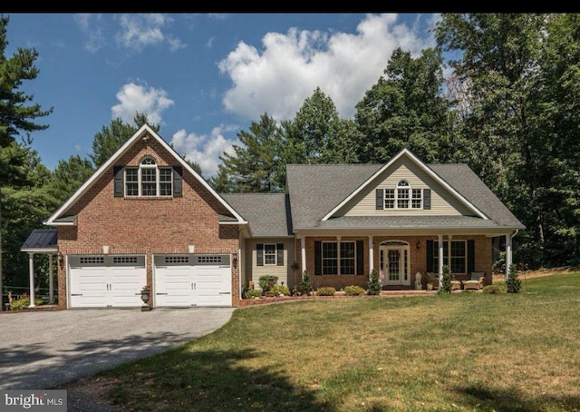 view of front of property with a front yard, driveway, an attached garage, french doors, and brick siding