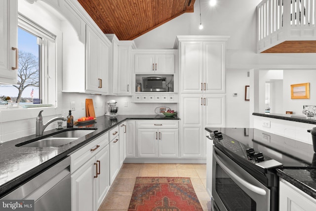 kitchen with wood ceiling, light tile patterned floors, white cabinets, stainless steel appliances, and a sink