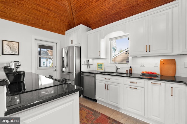 kitchen with white cabinets, wooden ceiling, stainless steel appliances, and a sink