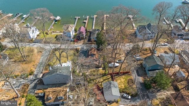 drone / aerial view with a residential view and a water view