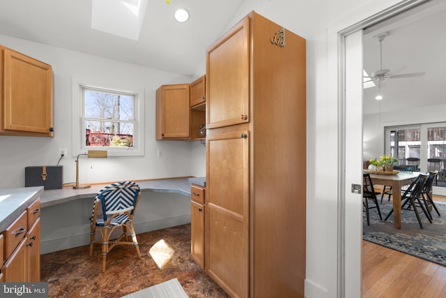 kitchen featuring vaulted ceiling with skylight, recessed lighting, a healthy amount of sunlight, and built in study area