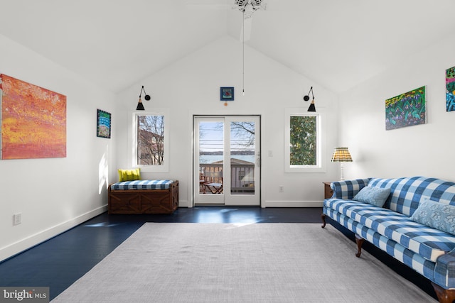 living area with a ceiling fan, wood finished floors, baseboards, and high vaulted ceiling