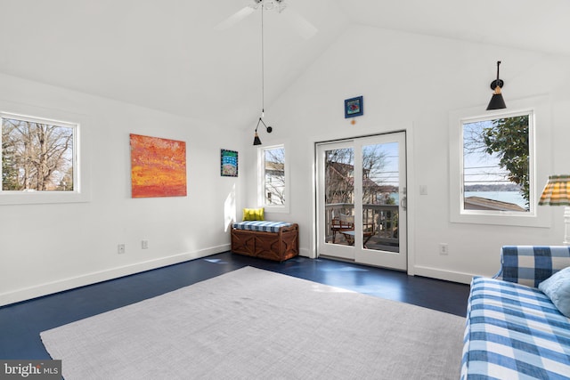 sitting room featuring baseboards and high vaulted ceiling