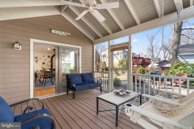 sunroom / solarium featuring lofted ceiling with beams, plenty of natural light, and ceiling fan