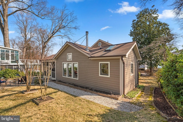 back of property with a garden and a lawn