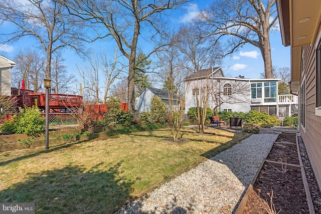 view of yard with a vegetable garden and a wooden deck