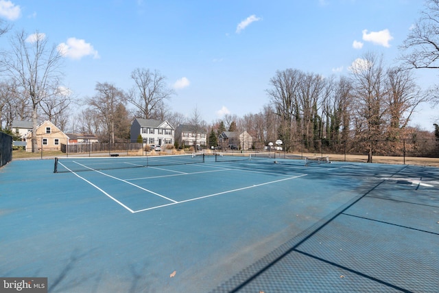 view of tennis court featuring fence