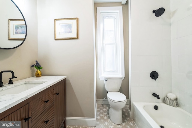 bathroom featuring vanity, toilet, washtub / shower combination, and baseboards