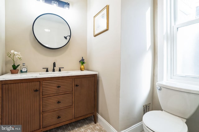 bathroom with tile patterned floors, toilet, vanity, and baseboards