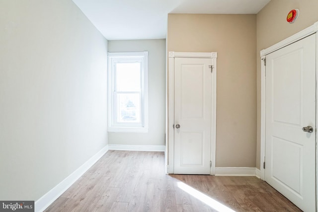 unfurnished bedroom featuring baseboards and light wood-style flooring