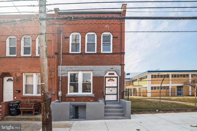 multi unit property featuring fence and brick siding