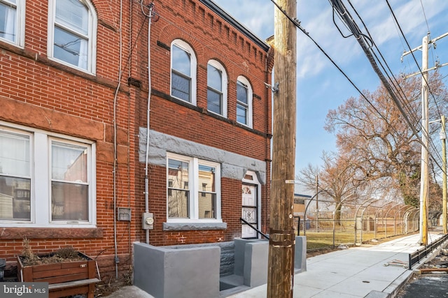 view of property exterior featuring brick siding