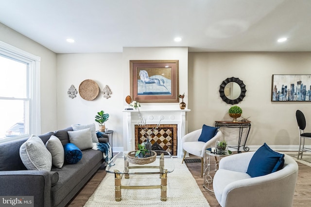 living area with recessed lighting, baseboards, and wood finished floors