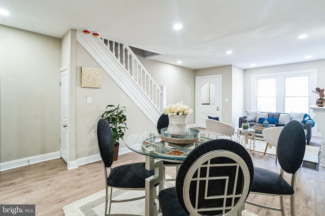 dining area featuring recessed lighting, light wood-style floors, and stairs