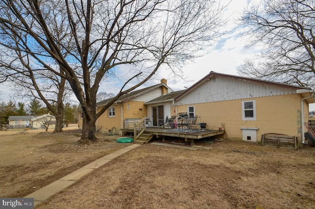 back of property with a deck