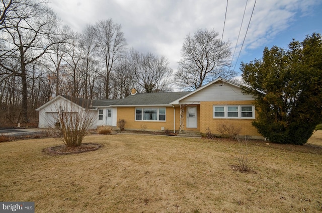 ranch-style home with a garage, brick siding, and a front yard