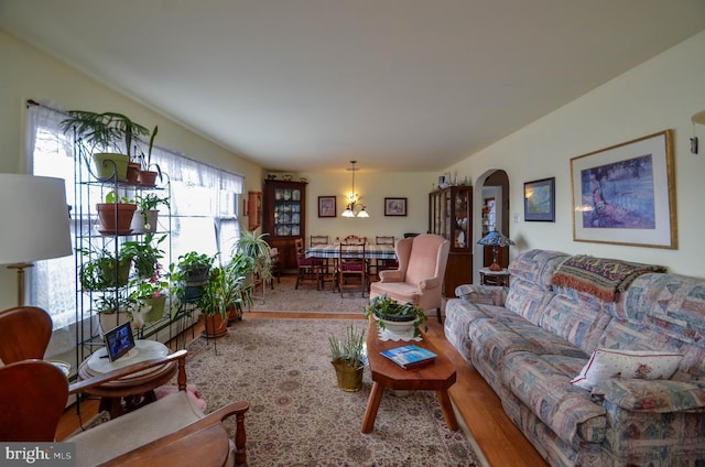 living room with wood finished floors and arched walkways