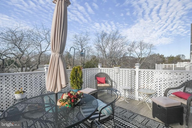 wooden terrace featuring outdoor dining area