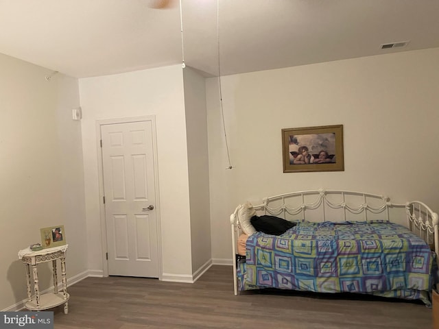 bedroom with visible vents, baseboards, and dark wood-style flooring