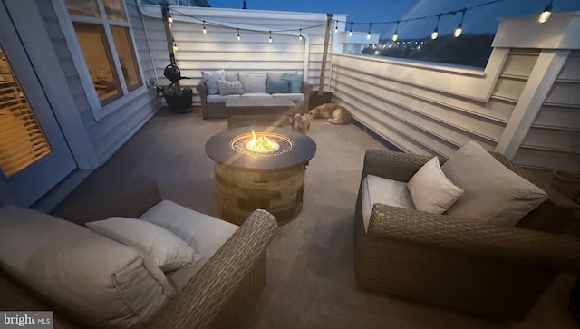 view of patio / terrace with a balcony and a fire pit