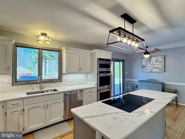 kitchen featuring white cabinets, appliances with stainless steel finishes, and a sink