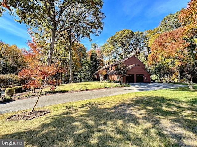 view of front of house with a front yard, a garage, and driveway