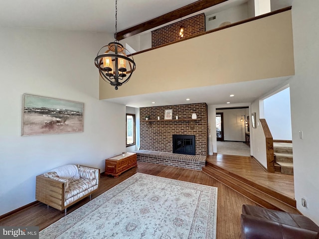 living room featuring a chandelier, plenty of natural light, and wood finished floors