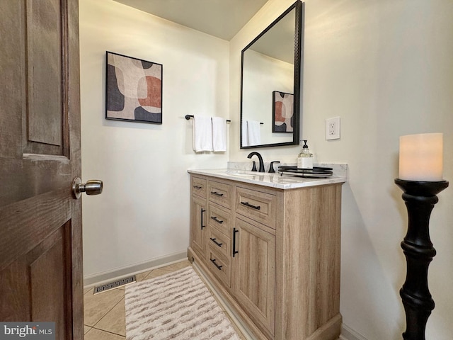 bathroom featuring tile patterned flooring, vanity, visible vents, and baseboards