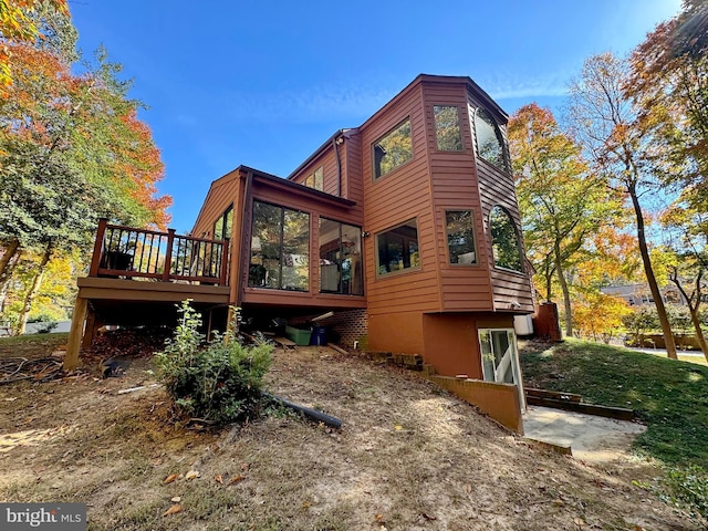 rear view of house with a wooden deck