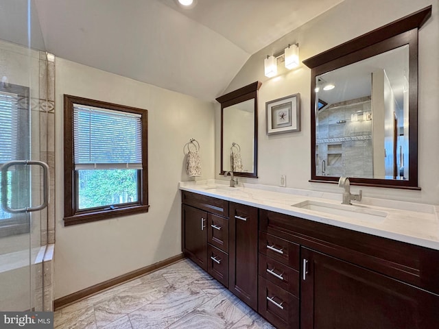 full bath featuring a shower stall, marble finish floor, lofted ceiling, and a sink