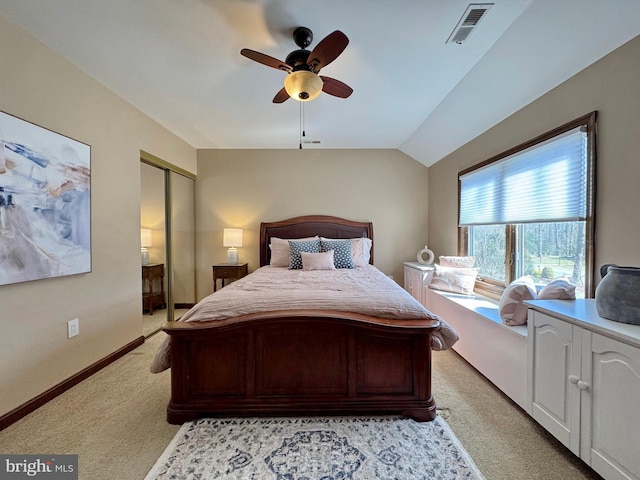 bedroom with visible vents, light carpet, lofted ceiling, a ceiling fan, and baseboards