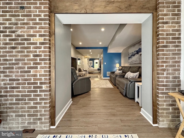 living area with recessed lighting, baseboards, and wood finished floors