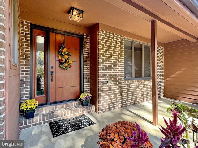 property entrance with brick siding