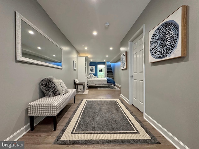 hallway featuring recessed lighting, baseboards, and wood finished floors