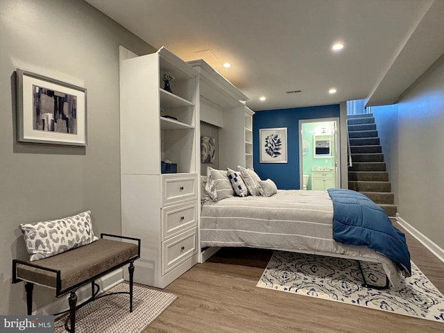 bedroom with visible vents, wood finished floors, recessed lighting, connected bathroom, and baseboards