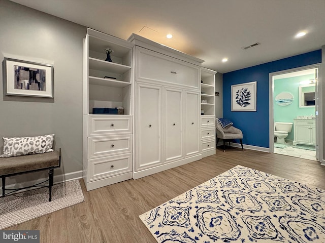 living area with recessed lighting, visible vents, baseboards, and light wood-style flooring