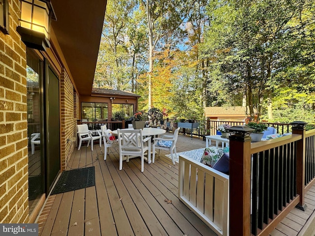 wooden deck featuring outdoor dining space