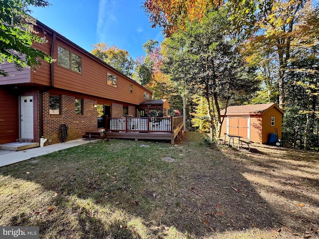 view of yard featuring a deck, an outdoor structure, and a storage unit