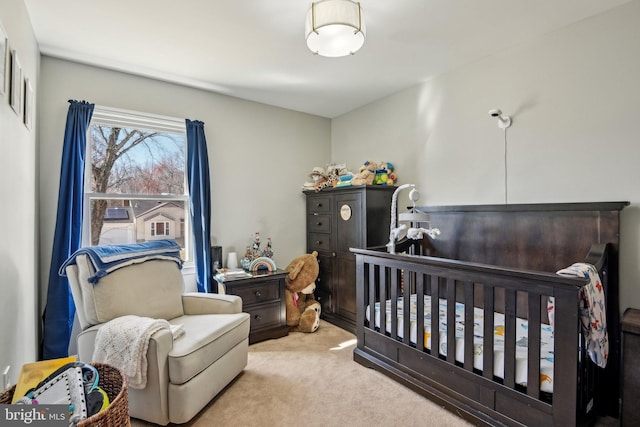 bedroom with a crib and carpet floors