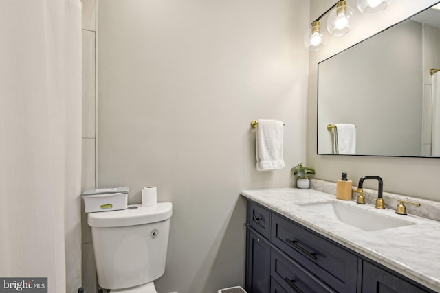 bathroom with toilet and vanity